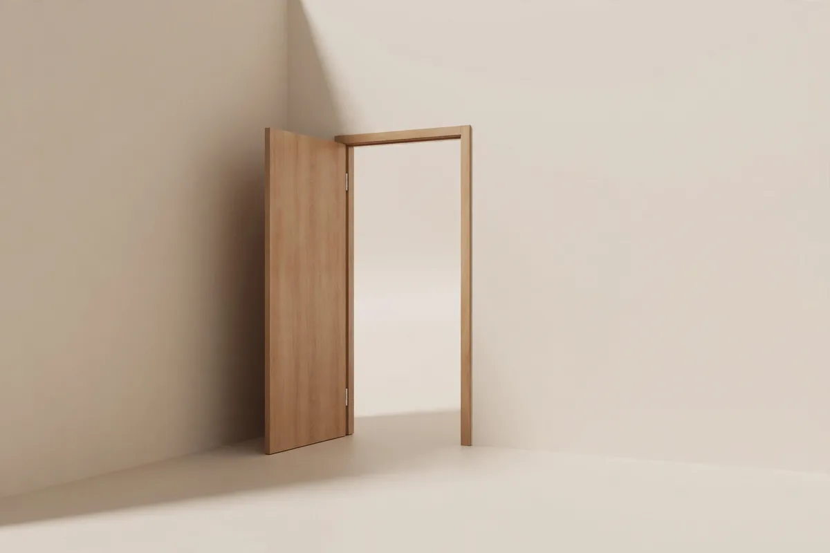 A corner of a doorway with an open door